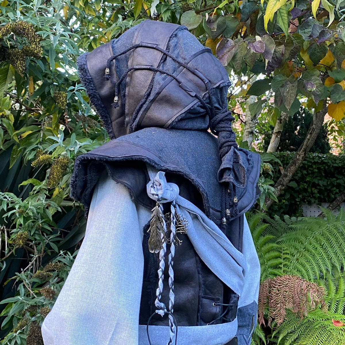Medieval LARP hood from back, black faux leather with braided details.