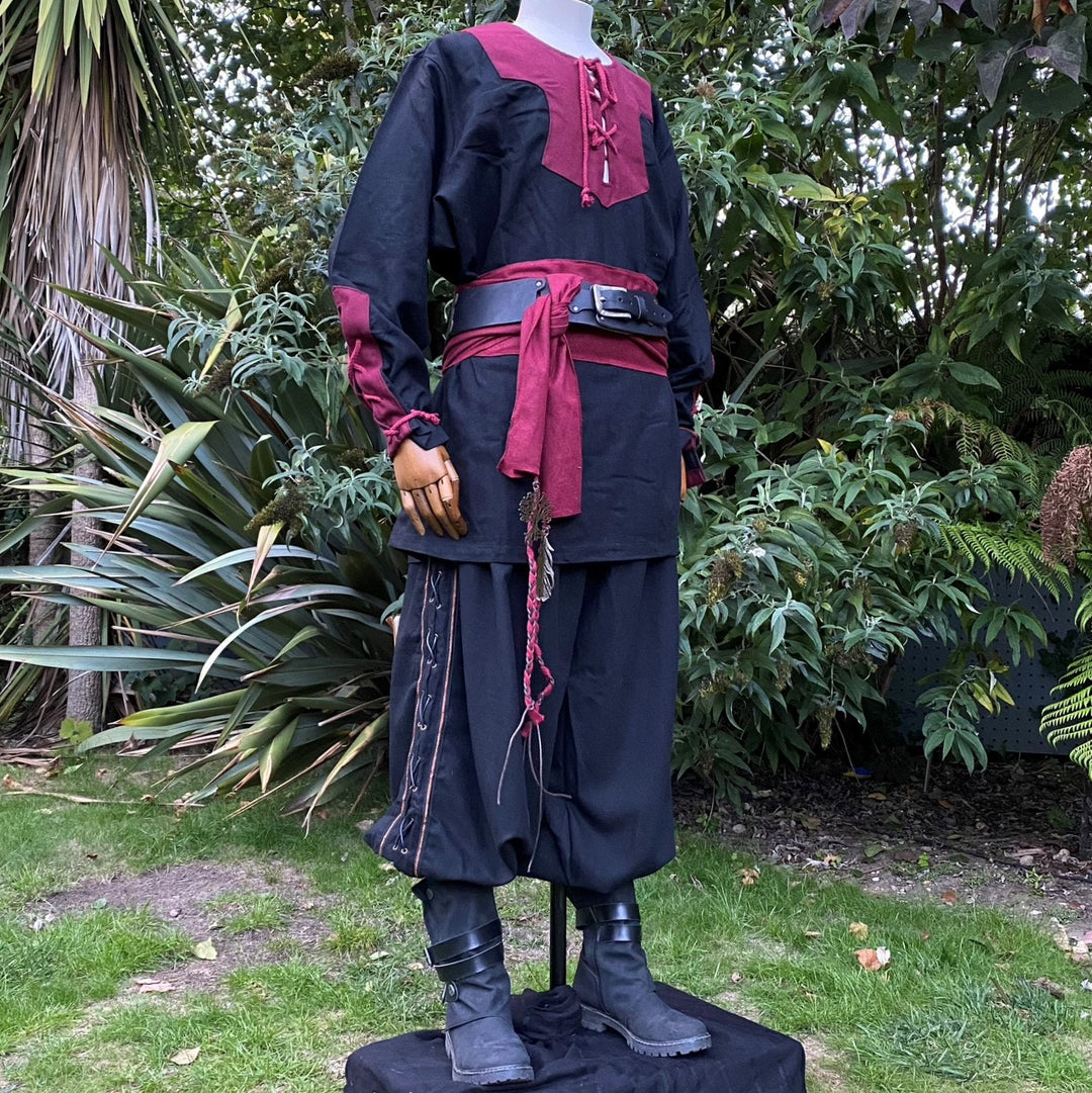 LARP Viking shirt in garden setting, black-red with braided trim detail.