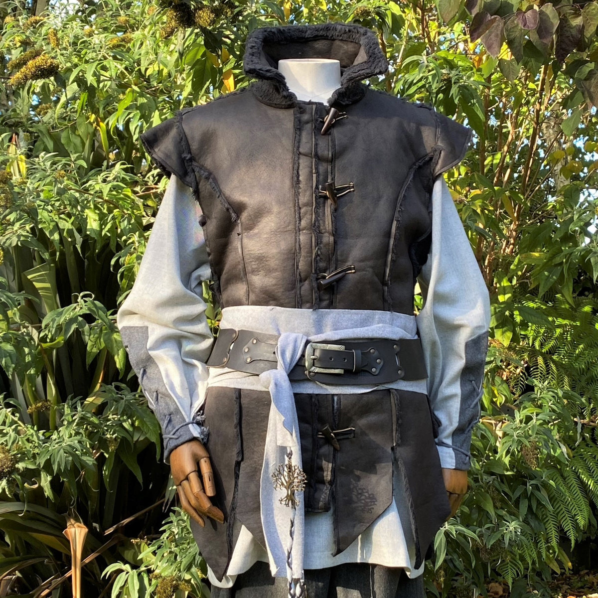Black medieval waistcoat with belt, shown.