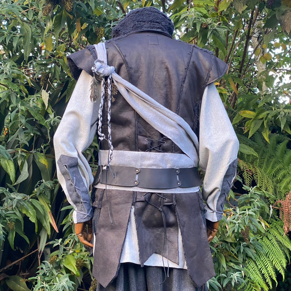 Back view of black faux leather waistcoat with flowing panel design for LARP and fantasy cosplay.