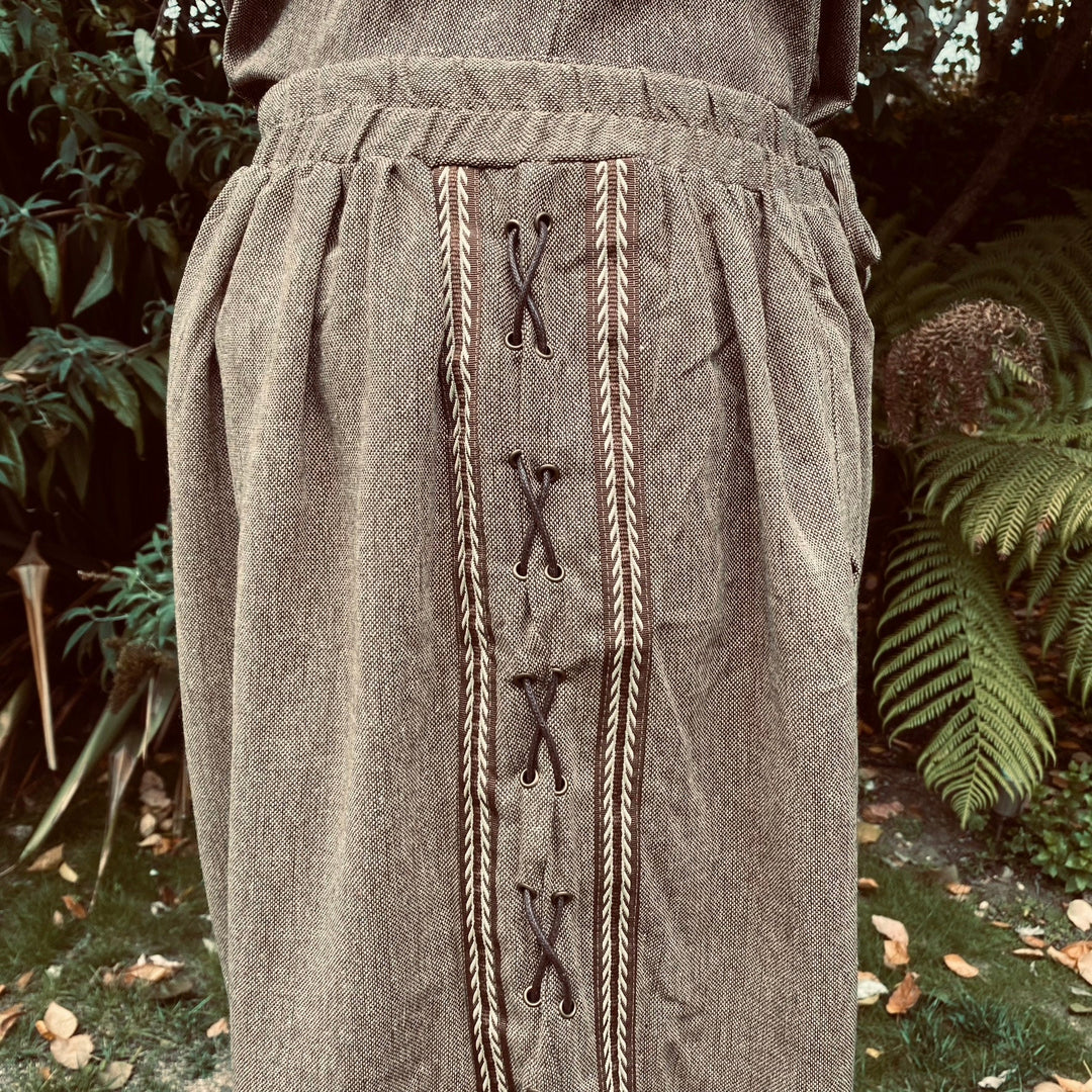 Side view of brown wool LARP pants with detailed laced pattern.