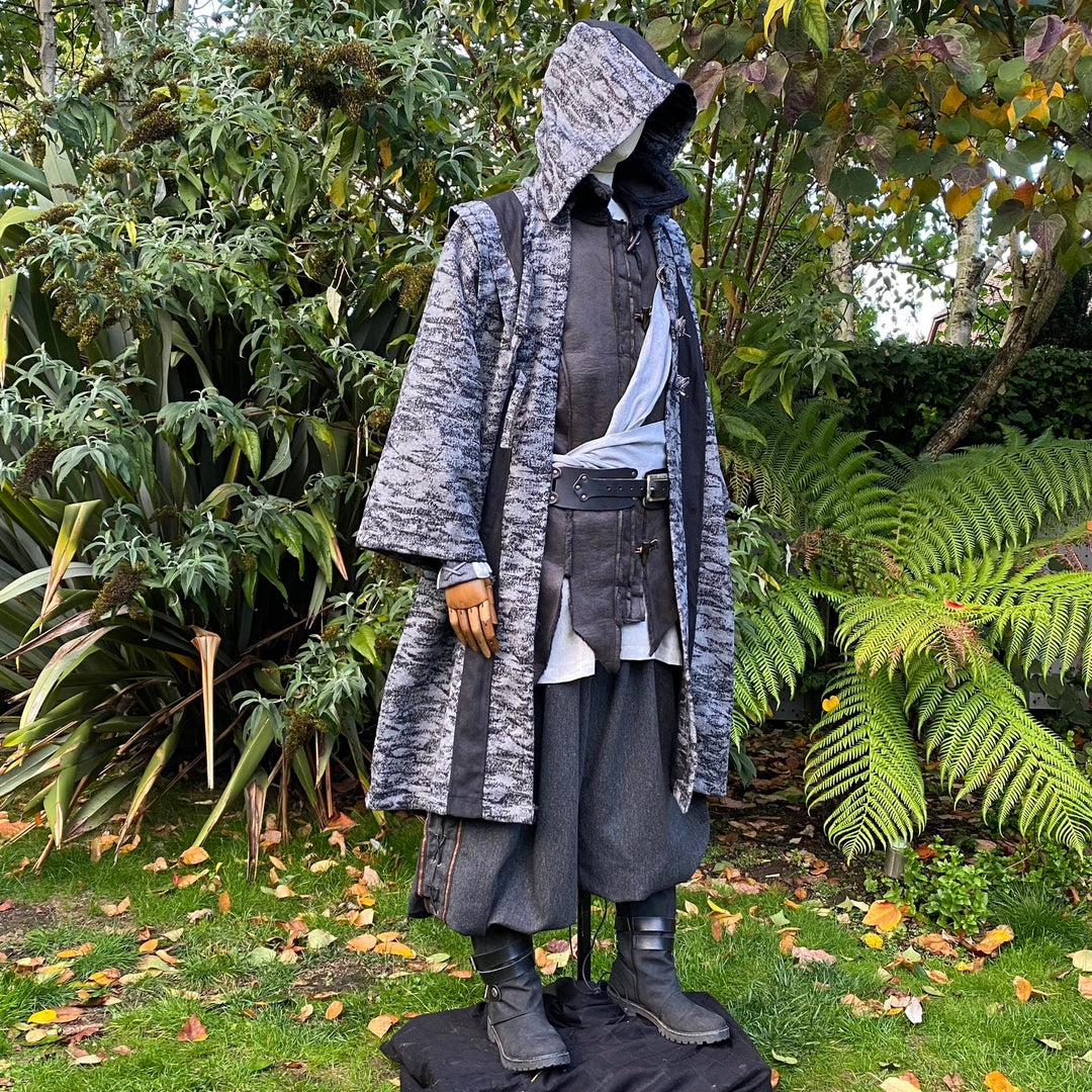 Medieval LARP costume side view, featuring grey and black hooded robe, and a grey woollen.