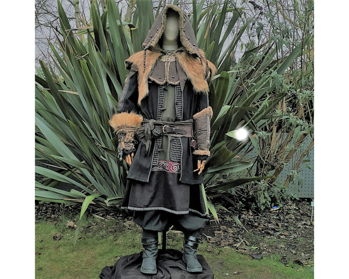 Medieval LARP attire with fur trim, hood, and vambraces.