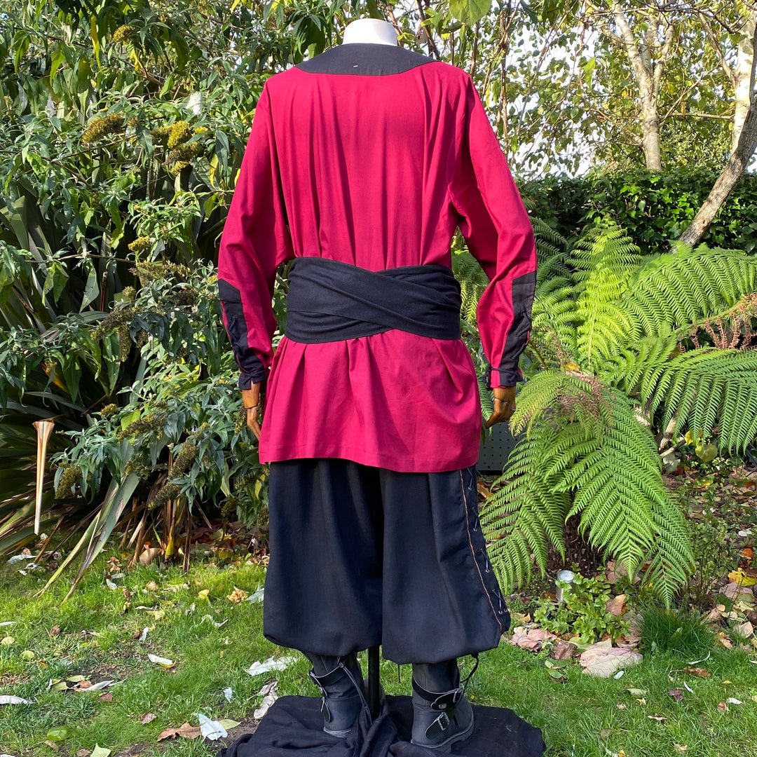 Back view of red-black Viking shirt on mannequin in garden for LARP.