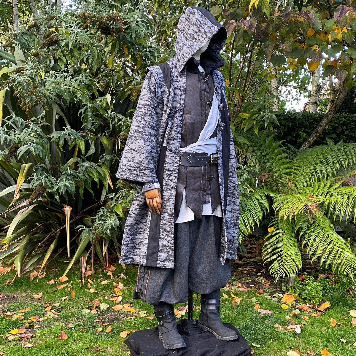 Medieval LARP costume side view, featuring faux leather hood and waistcoat, grey and black.