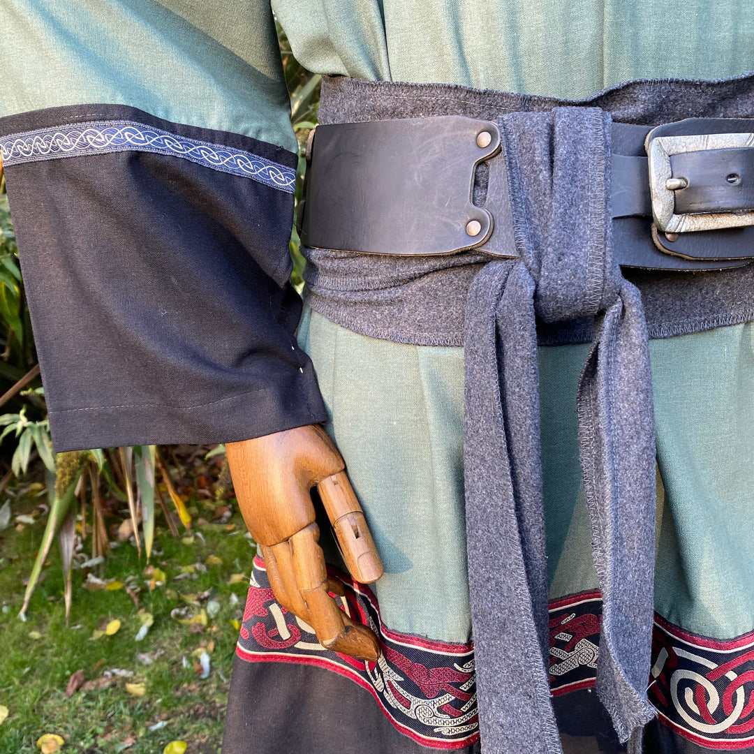 LARP tunic close-up: green-black with Celtic trim and detailed sash.