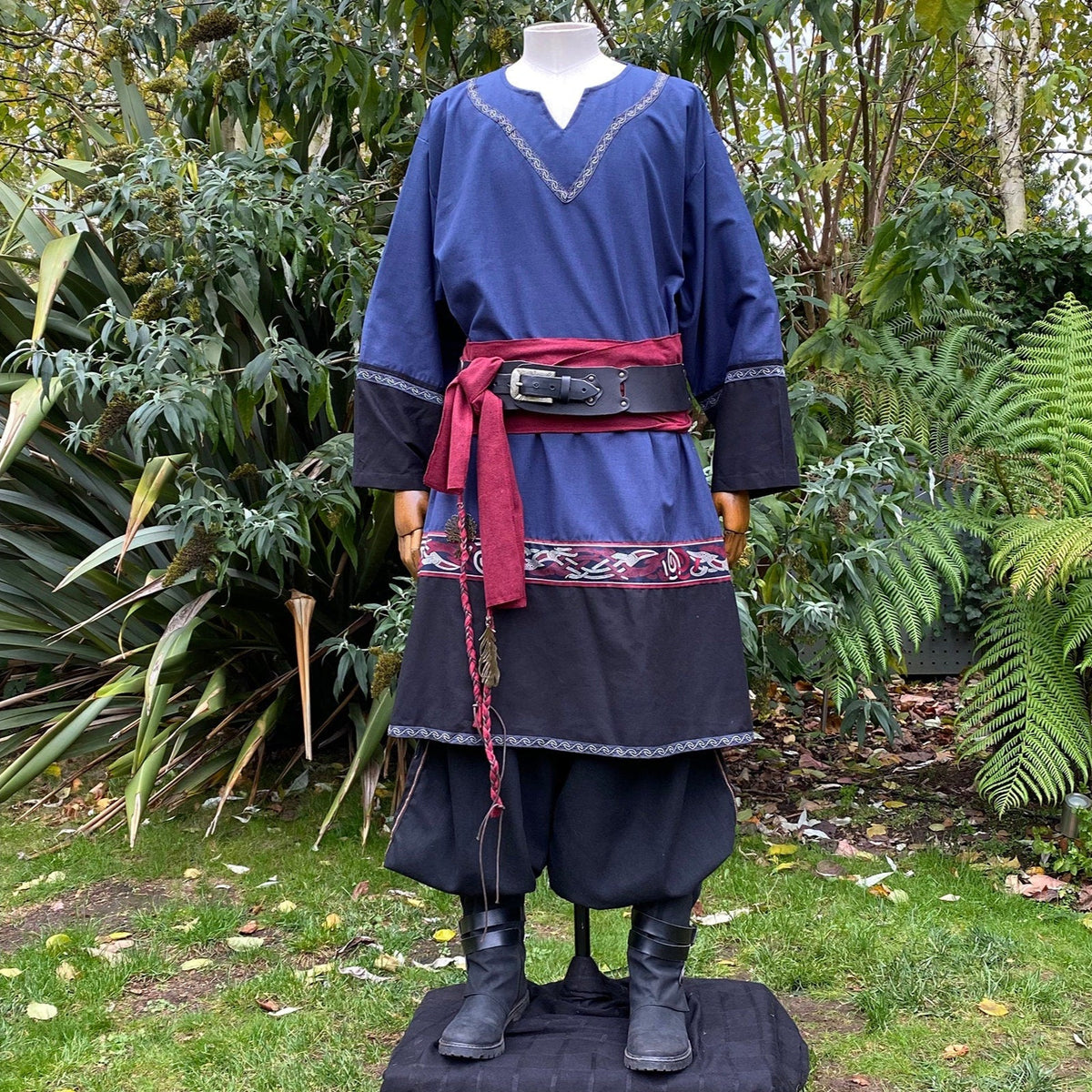 Medieval LARP outfit front view, featuring a blue and black Viking tunic, trousers and sash.