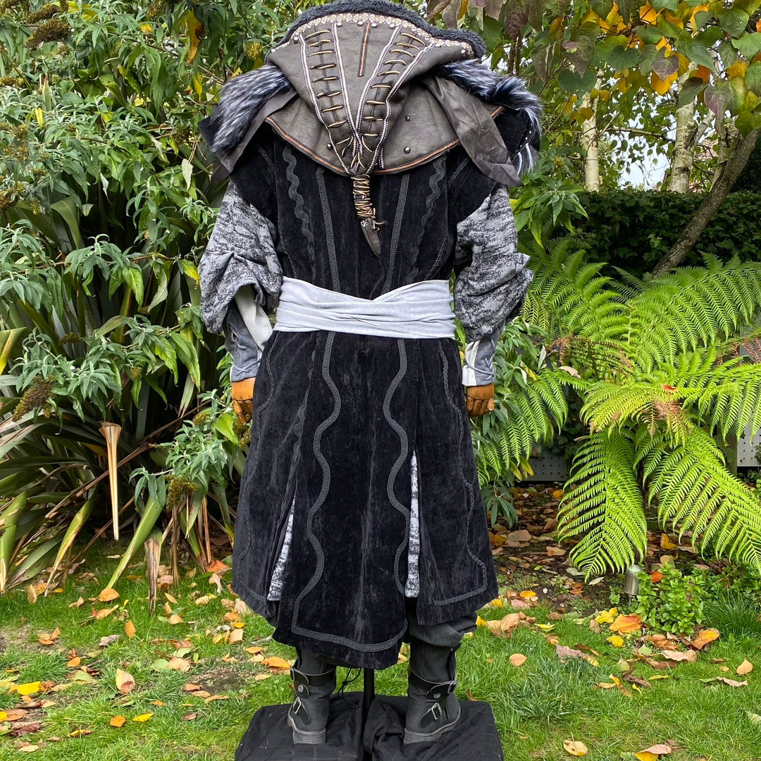 Back view of medieval mage LARP outfit with ornate hood and white sash.