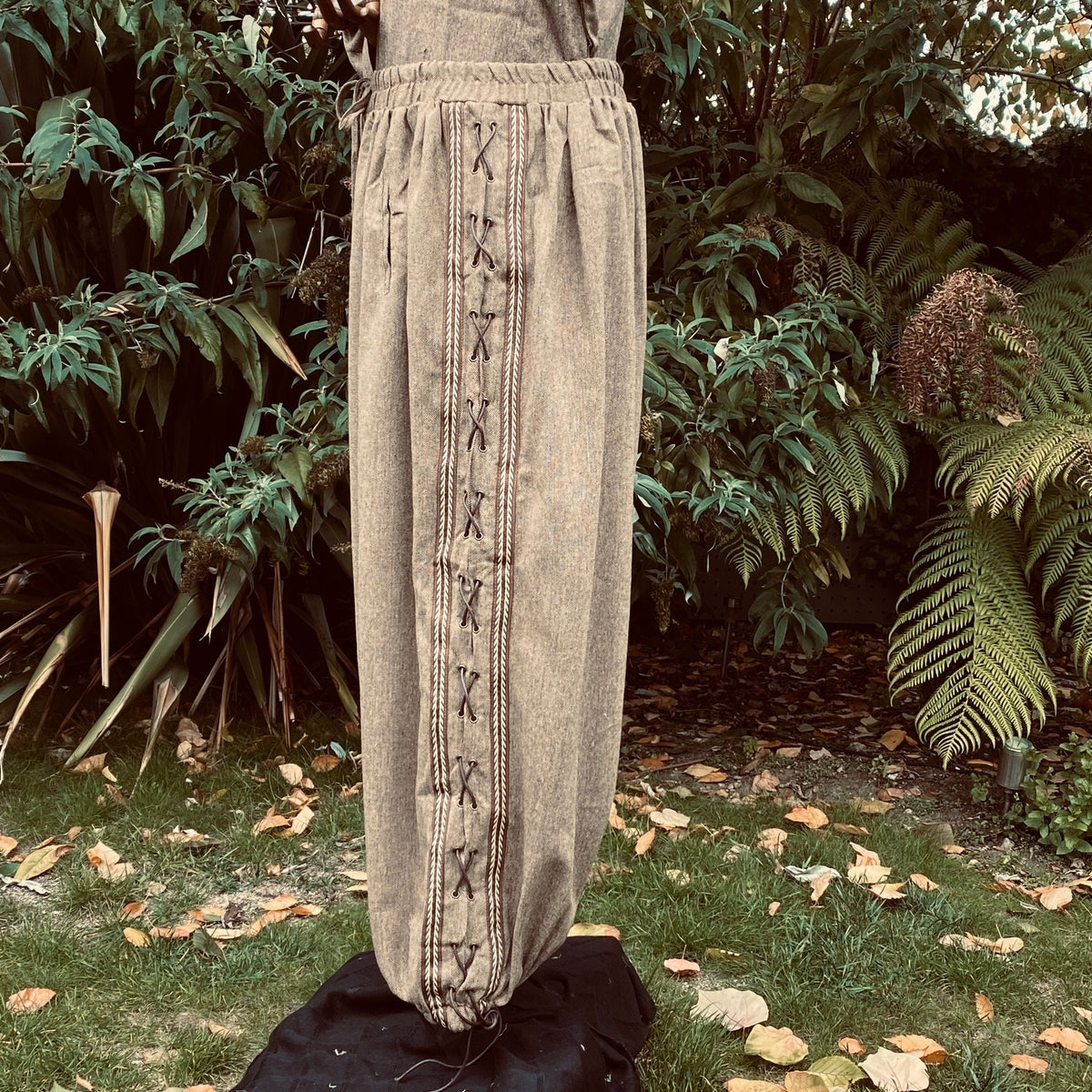 Side view of brown wool medieval trousers with detailed lace design for LARP.
