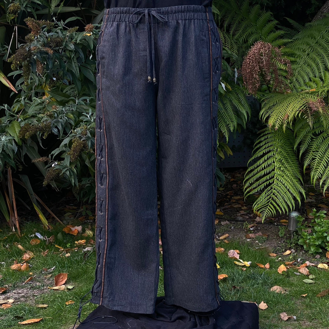 Front garden view of LARP medieval grey pants with braided side lacing.