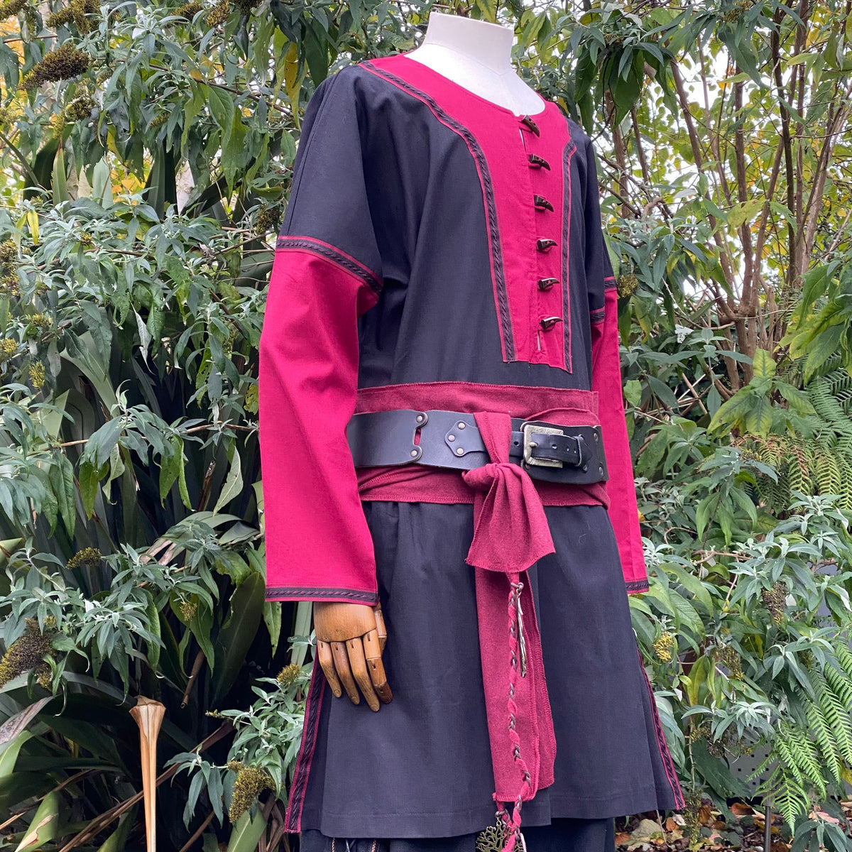 Mannequin in medieval tunic with red and black LARP outfit, side.