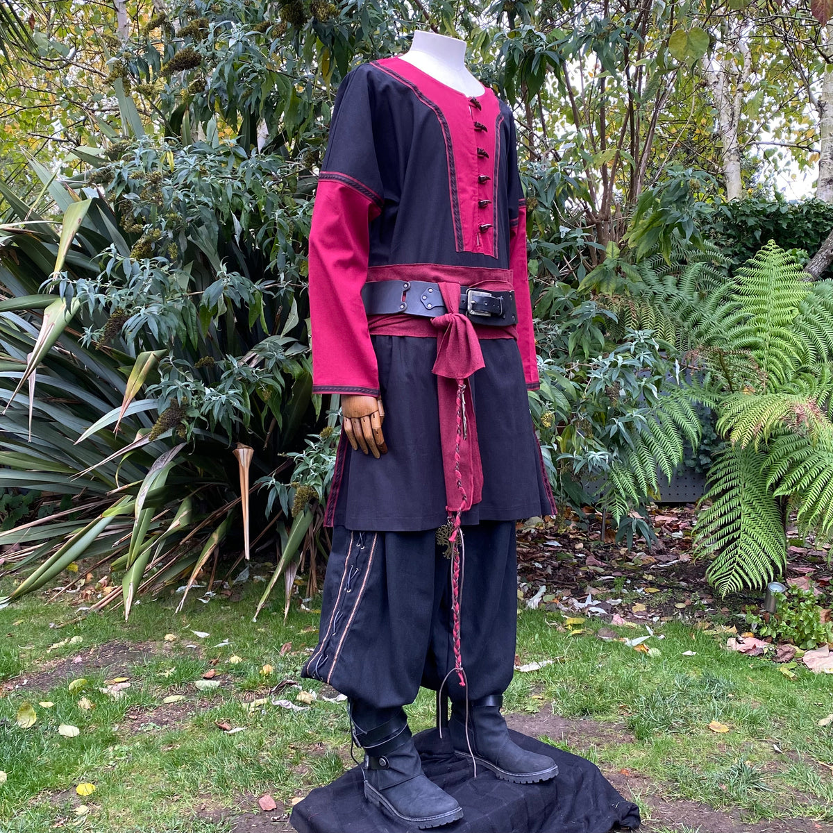 Two-tone Viking tunic with belt, red accents, LARP setting.