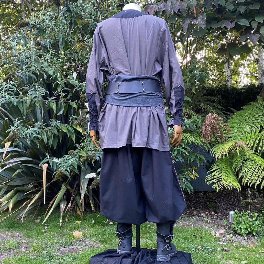 Back view of LARP outfit with grey sash and loose pants.