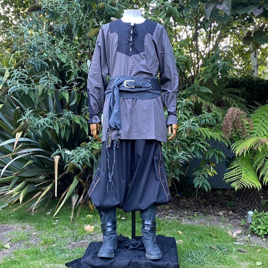 Medieval LARP outfit on mannequin in garden, showcasing grey and black attire.