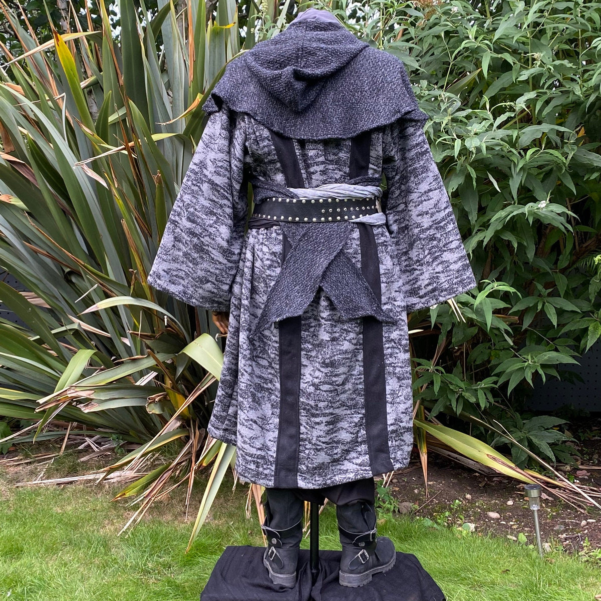 Medieval LARP costume back view, featuring grey and black hooded robe, and a grey woollen.