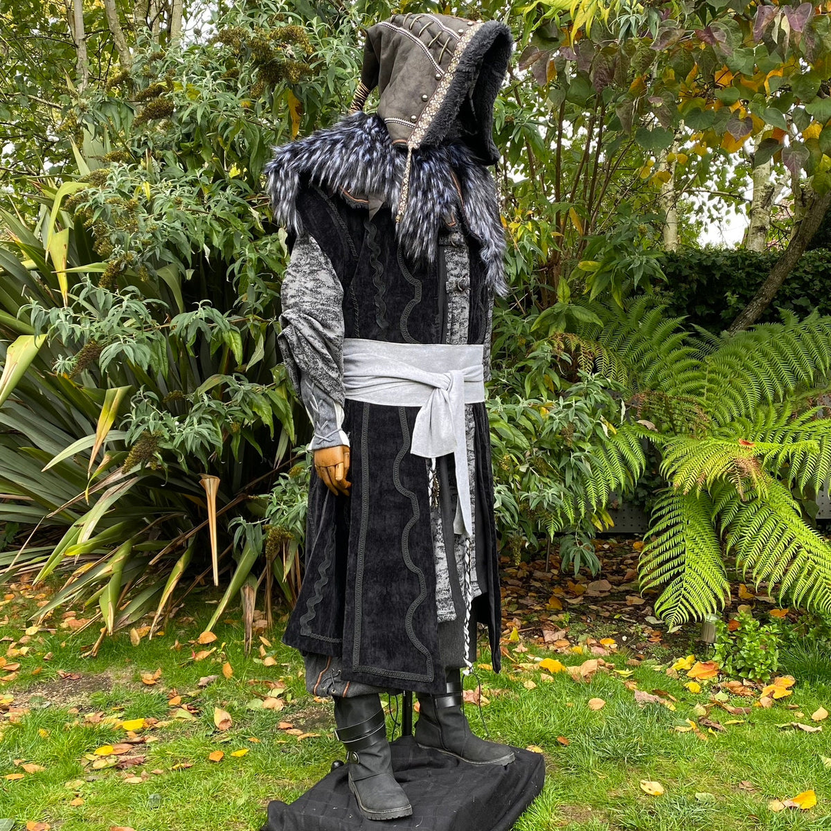 Medieval LARP outfit with fur-trimmed hood and grey sash.