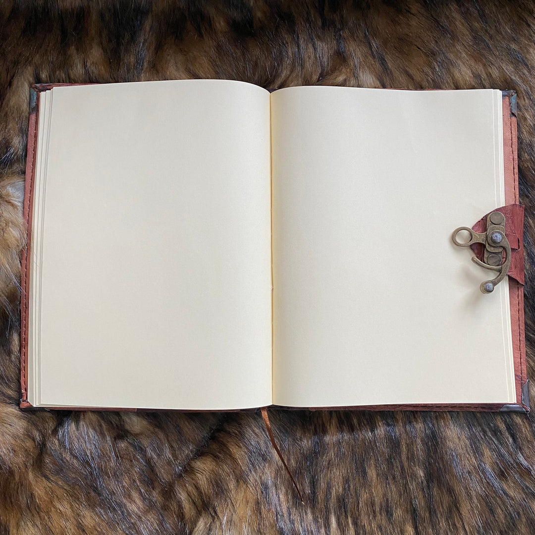Open leather journal on fur, showcasing medieval metal clasp for LARP.