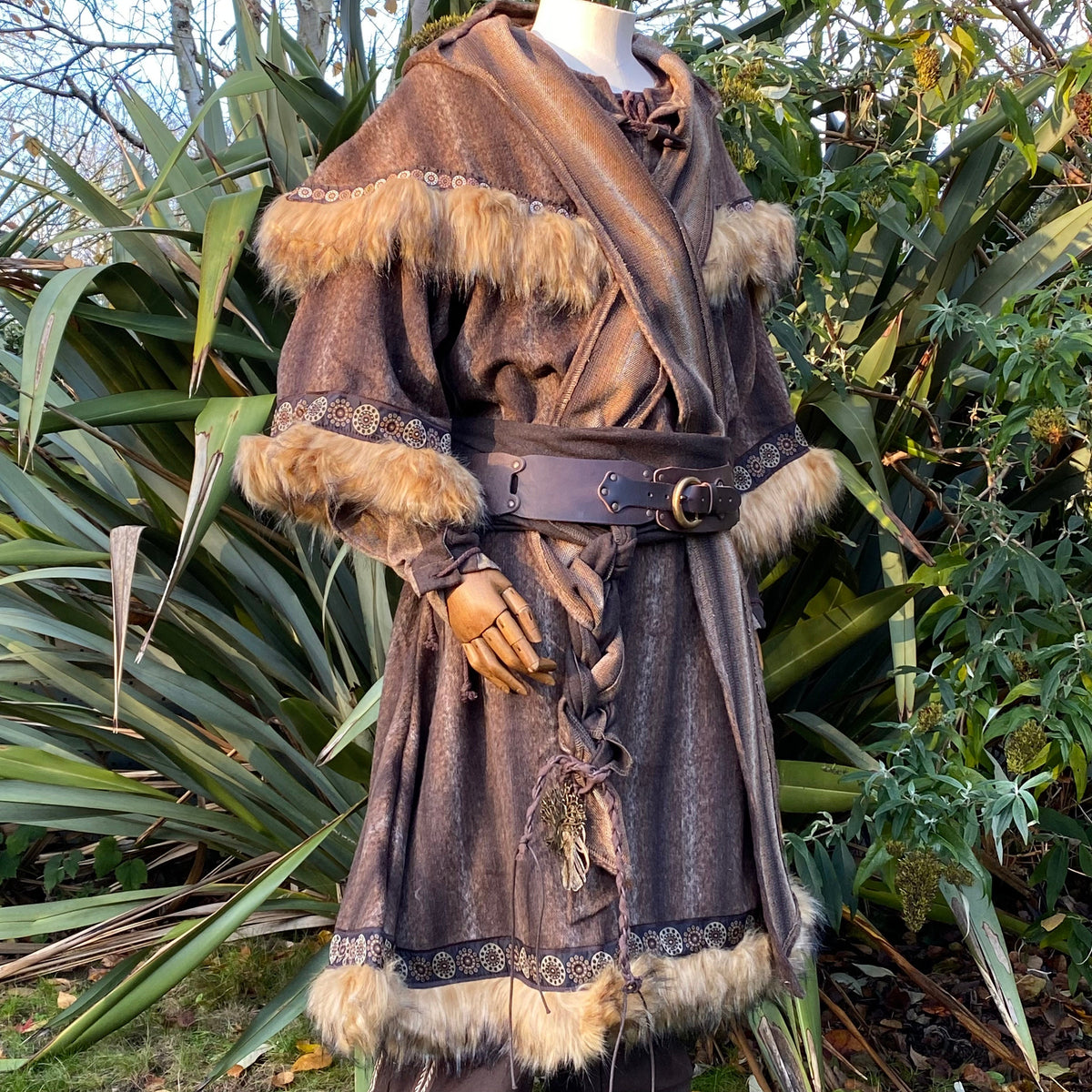 Medieval LARP outfit, close-up of fur-trimmed tunic and hood with leather belt.