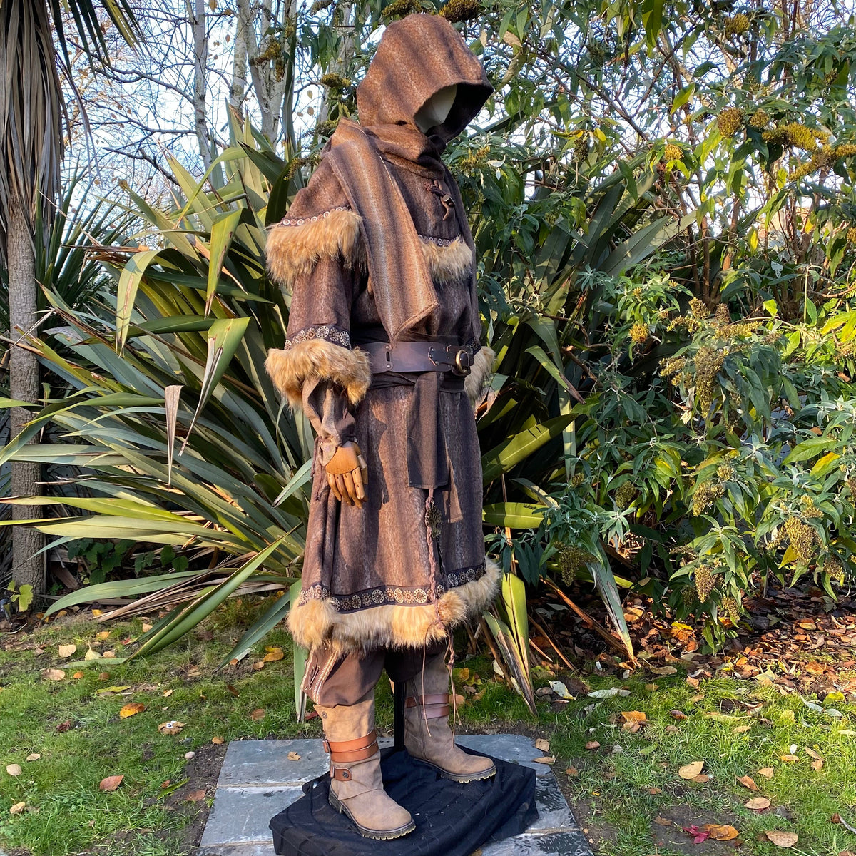 LARP brown tunic and hood with fur trim, side view in wooded area.