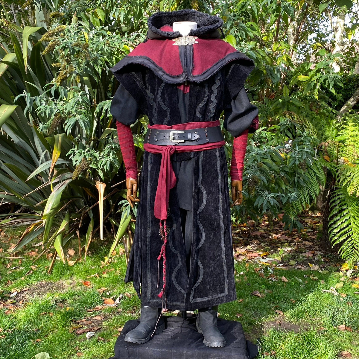 Medieval LARP outfit with red sash, black belt, and cloak.
