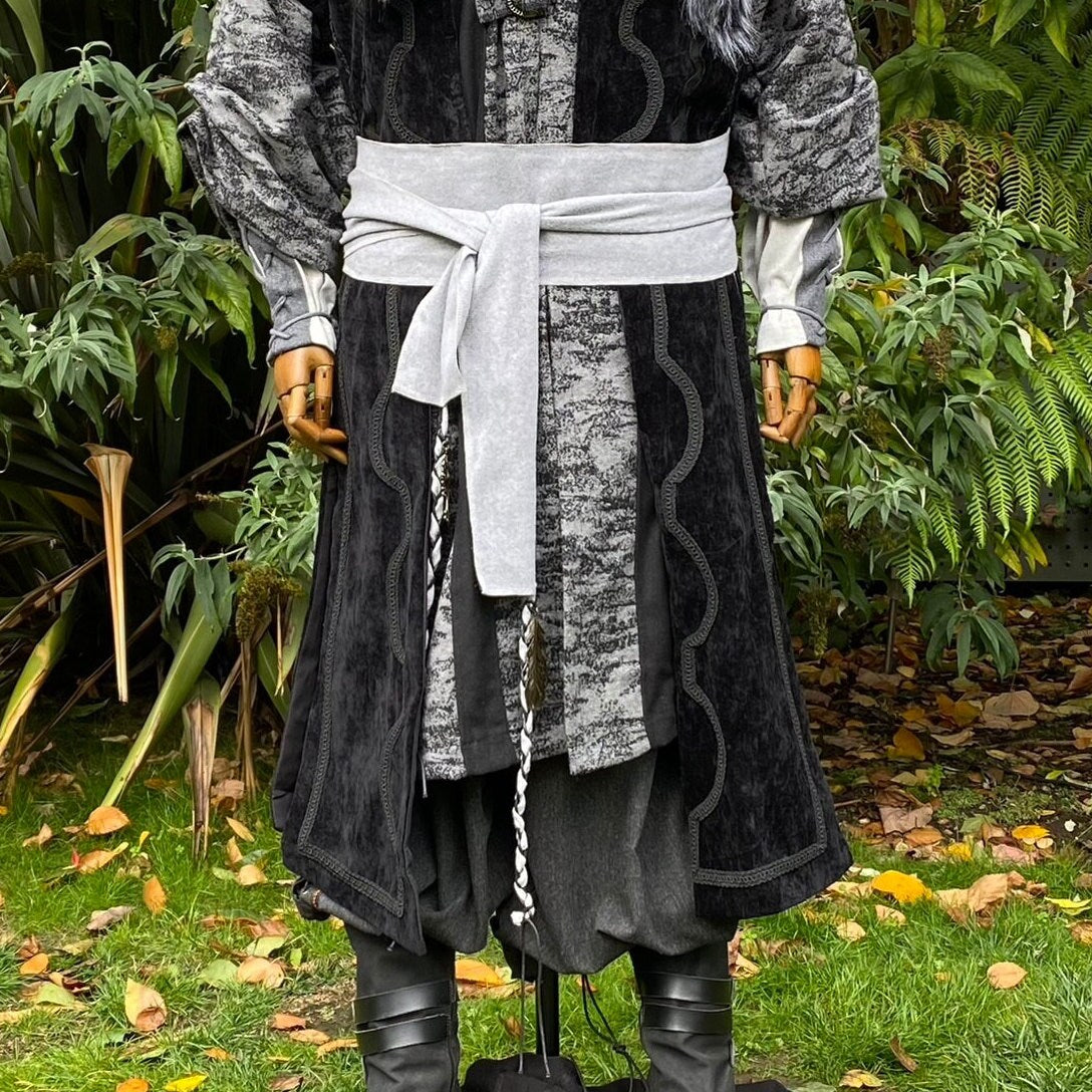 Medieval LARP outfit with grey sash and black accessories.