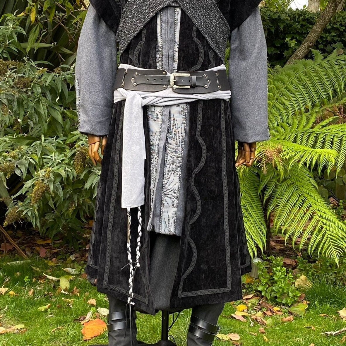 Medieval LARP attire with detailed grey belt and braided sash.