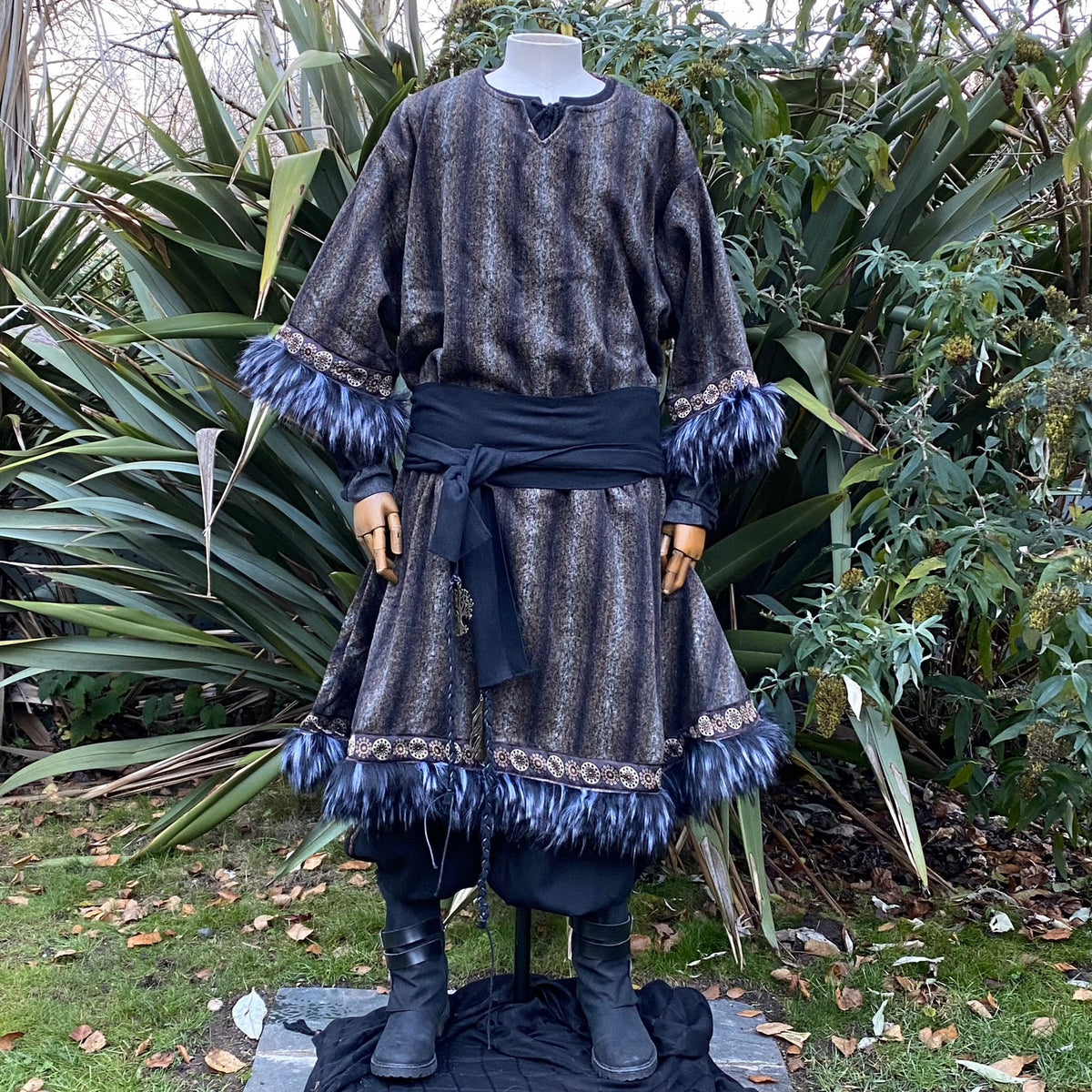 Viking tunic with blue fur trim, outdoor medieval LARP setting, frontal view.