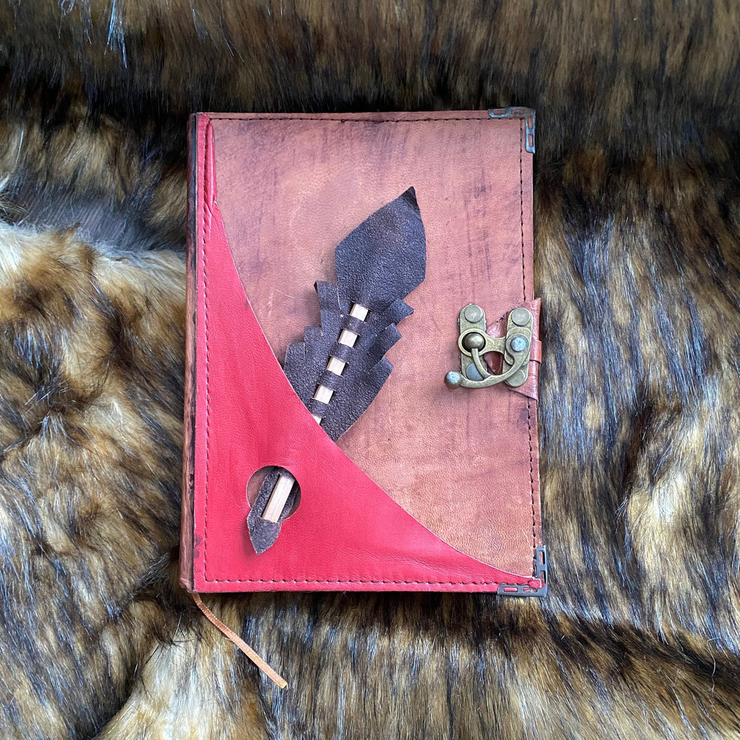 Medieval-style journal with red leather detail and metal clasp for LARP use.
