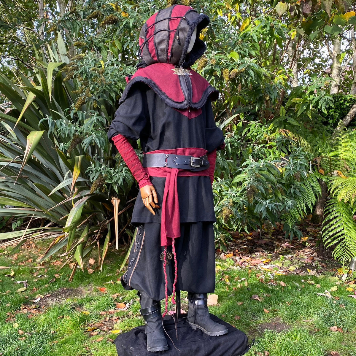 Medieval LARP hooded outfit with red belt, side view.