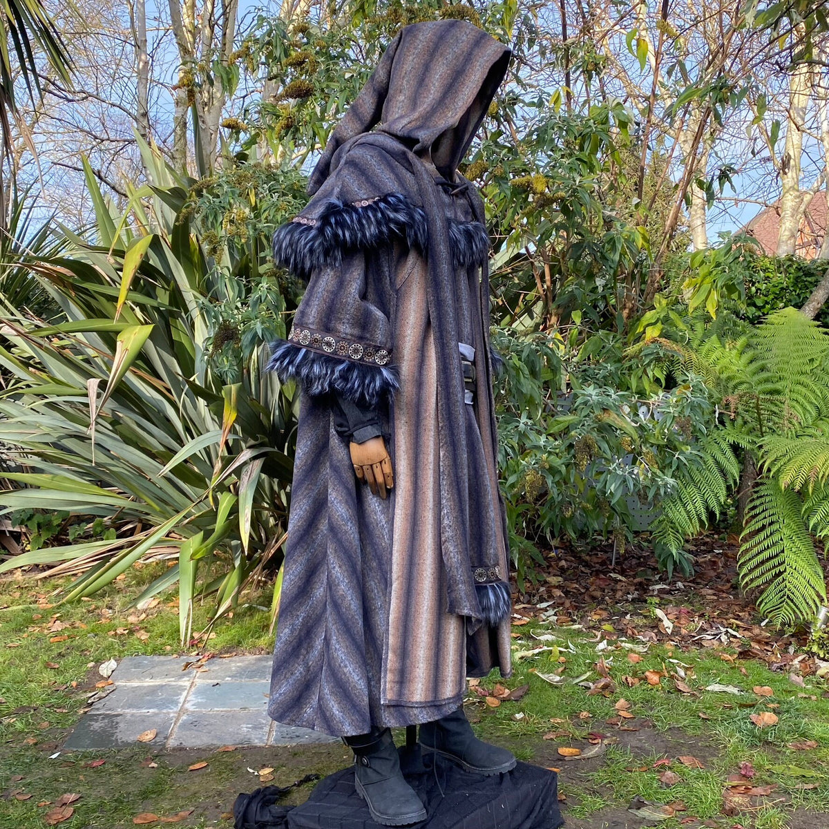 Medieval LARP outfit side view, featuring a blue and grey hooded cloak, tunic, hood, and sash.