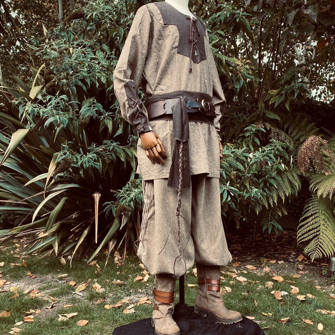 Medieval LARP attire: brown two-tone shirt, pants, sash.