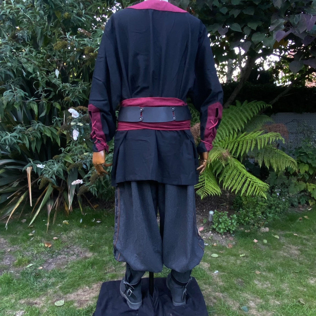 Medieval LARP outfit back view, featuring a black and red viking tunic, trousers and sash.