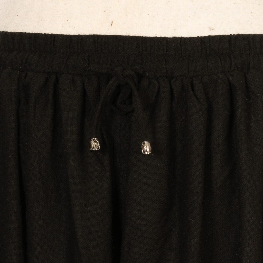 Medieval black wool pants waistband with metal-tipped drawstring.