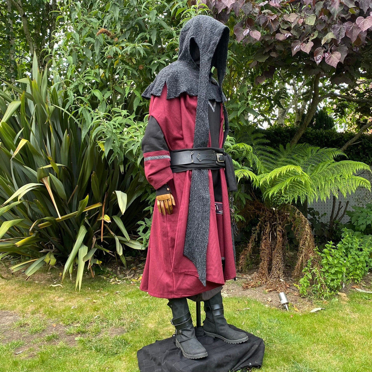 Medieval LARP outfit with hooded cloak and black belt.