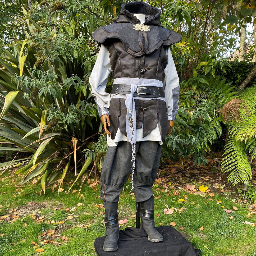 Medieval LARP outfit front view, featuring a black hood and waistcoat, grey cotton shirt, and sash.