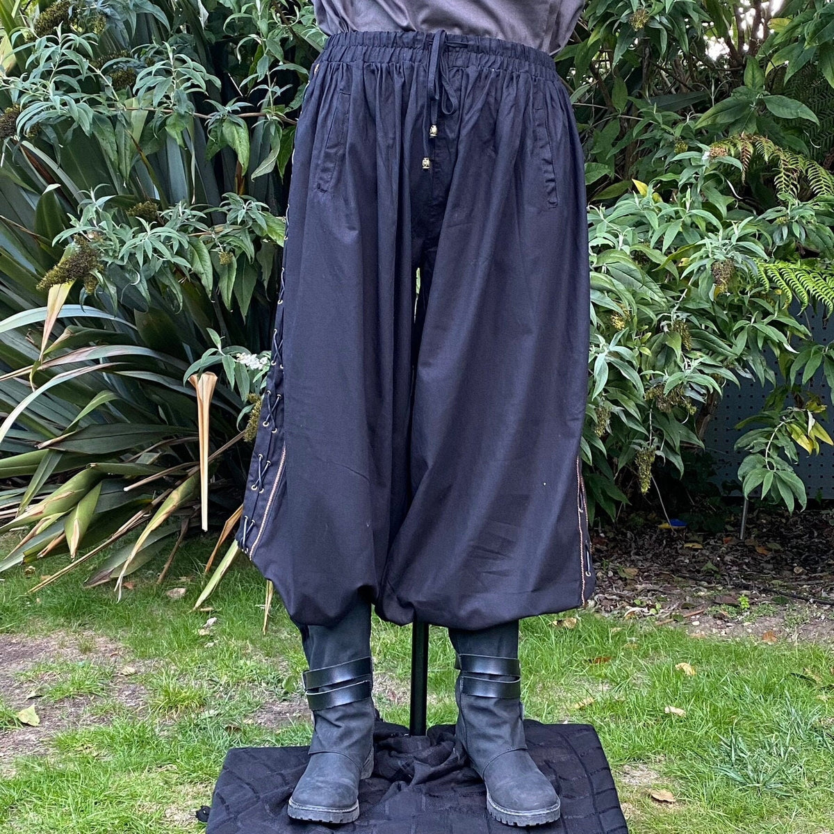 Black cotton LARP hero pants with side lace and braiding, position 1 view.