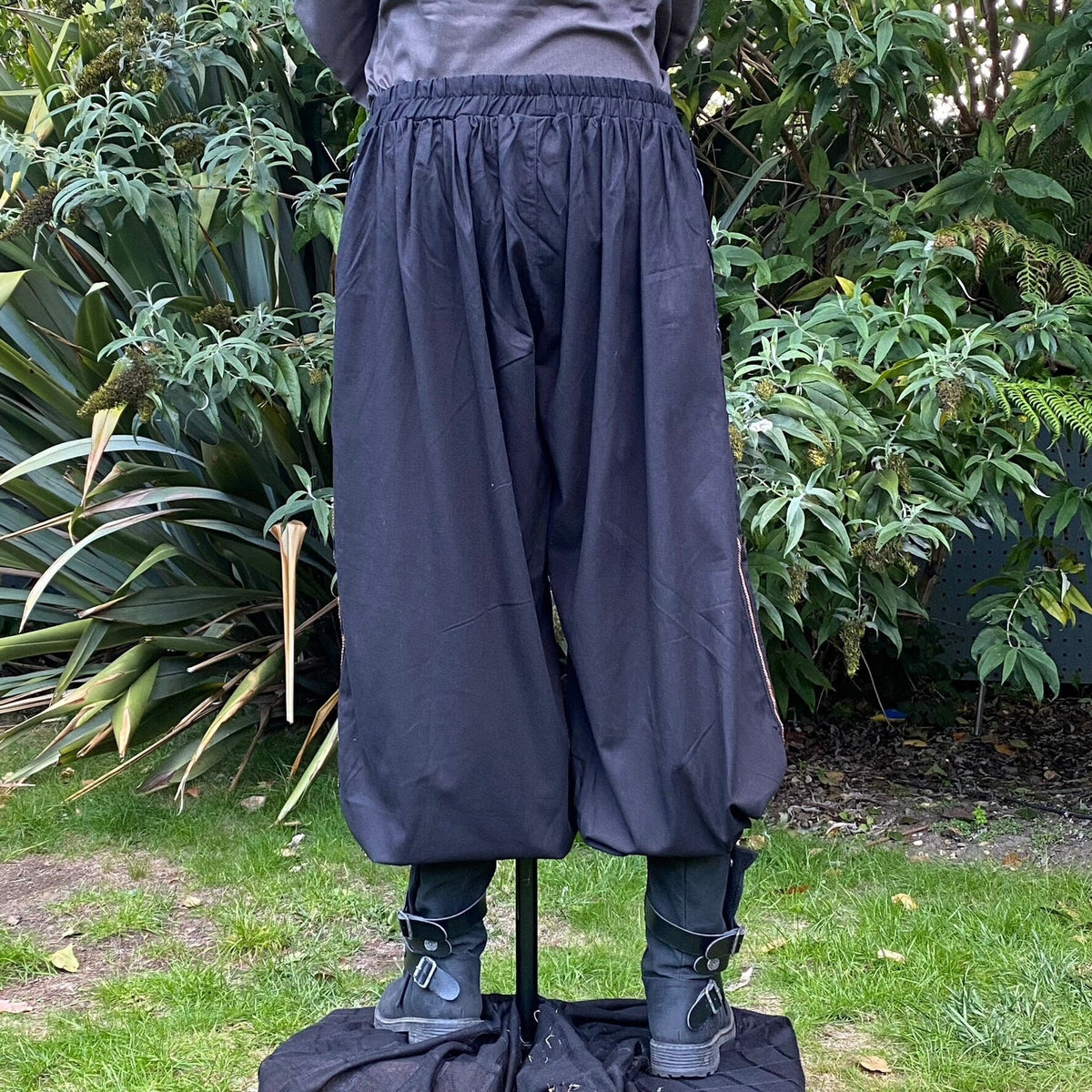 Back view of loose black LARP trousers with gathered waist.