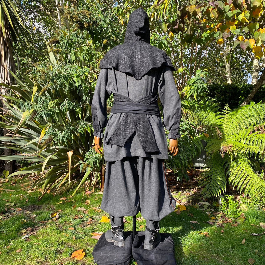 Rear view of LARP outfit in garden; grey hooded cloak and Viking pants.