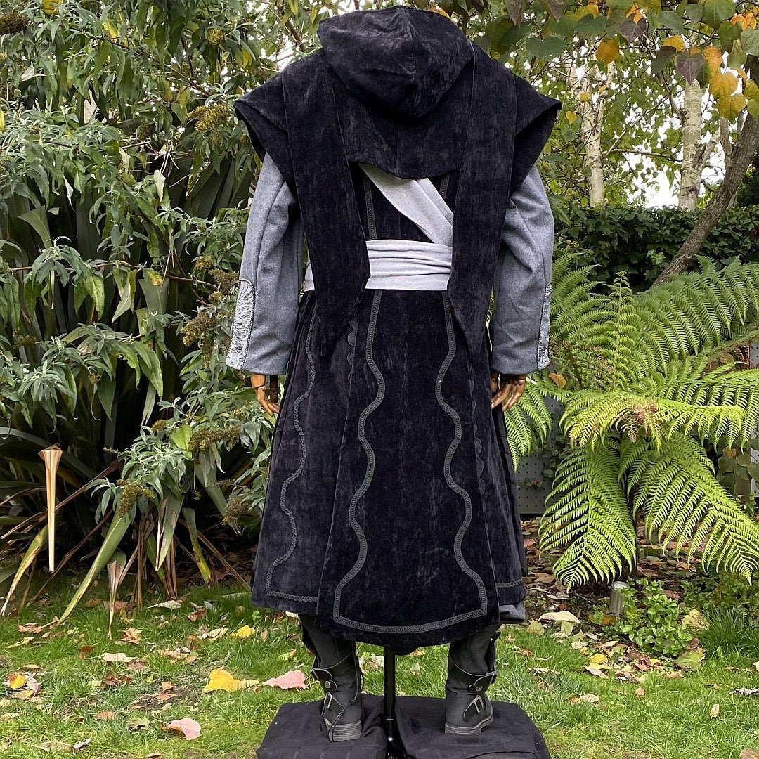 Back view of dark hooded coat for medieval LARP, grey accents.