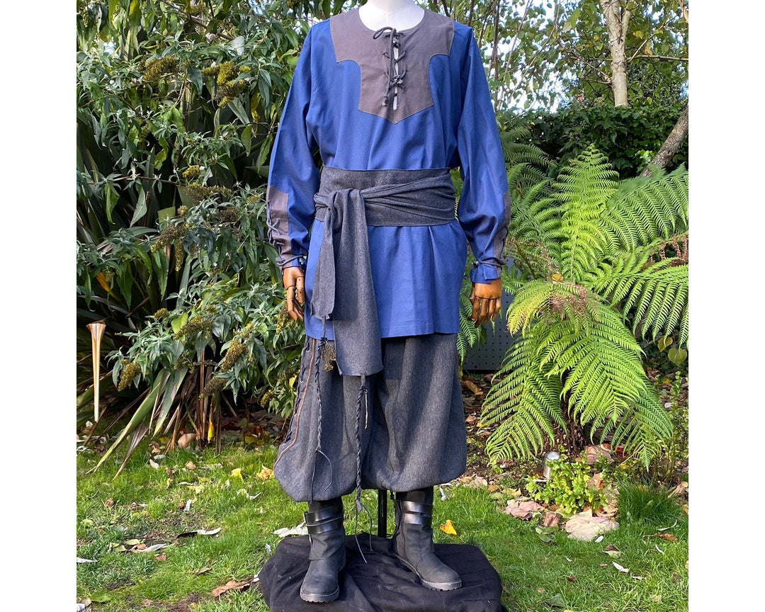 Medieval LARP outfit with blue shirt, sash, and boots.