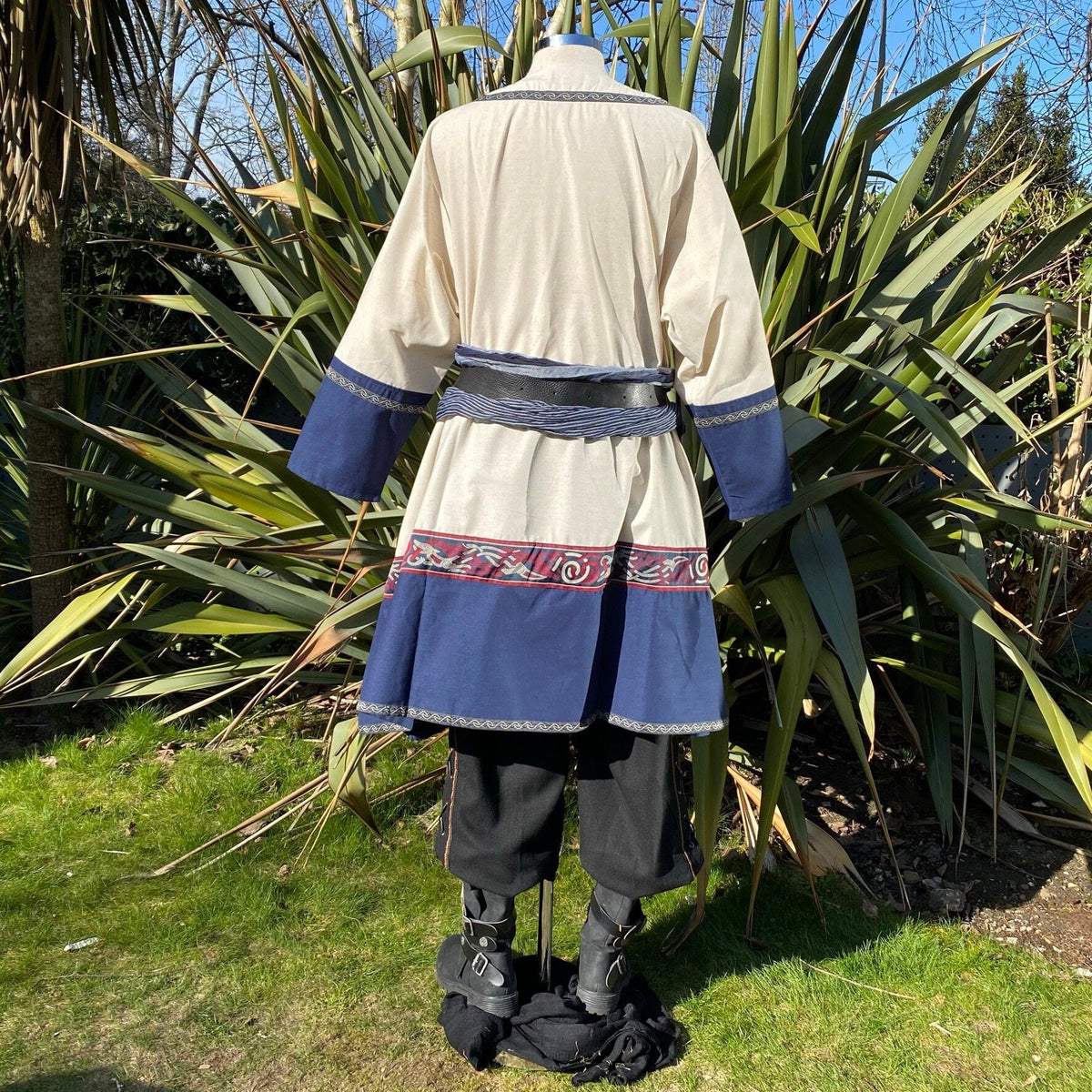 Back view of LARP Viking tunic, blue cuffs, embroidered hem.