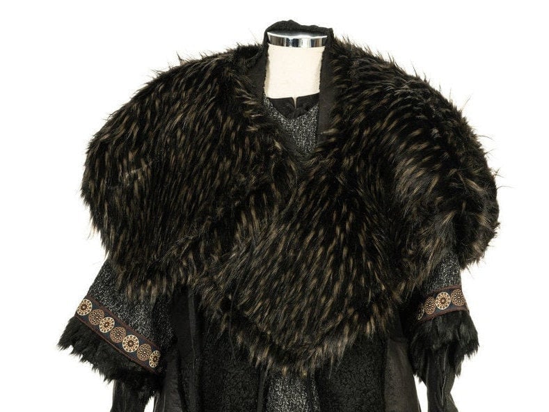 LARP medieval fur mantle in dark tones, draped over a tunic on mannequin.