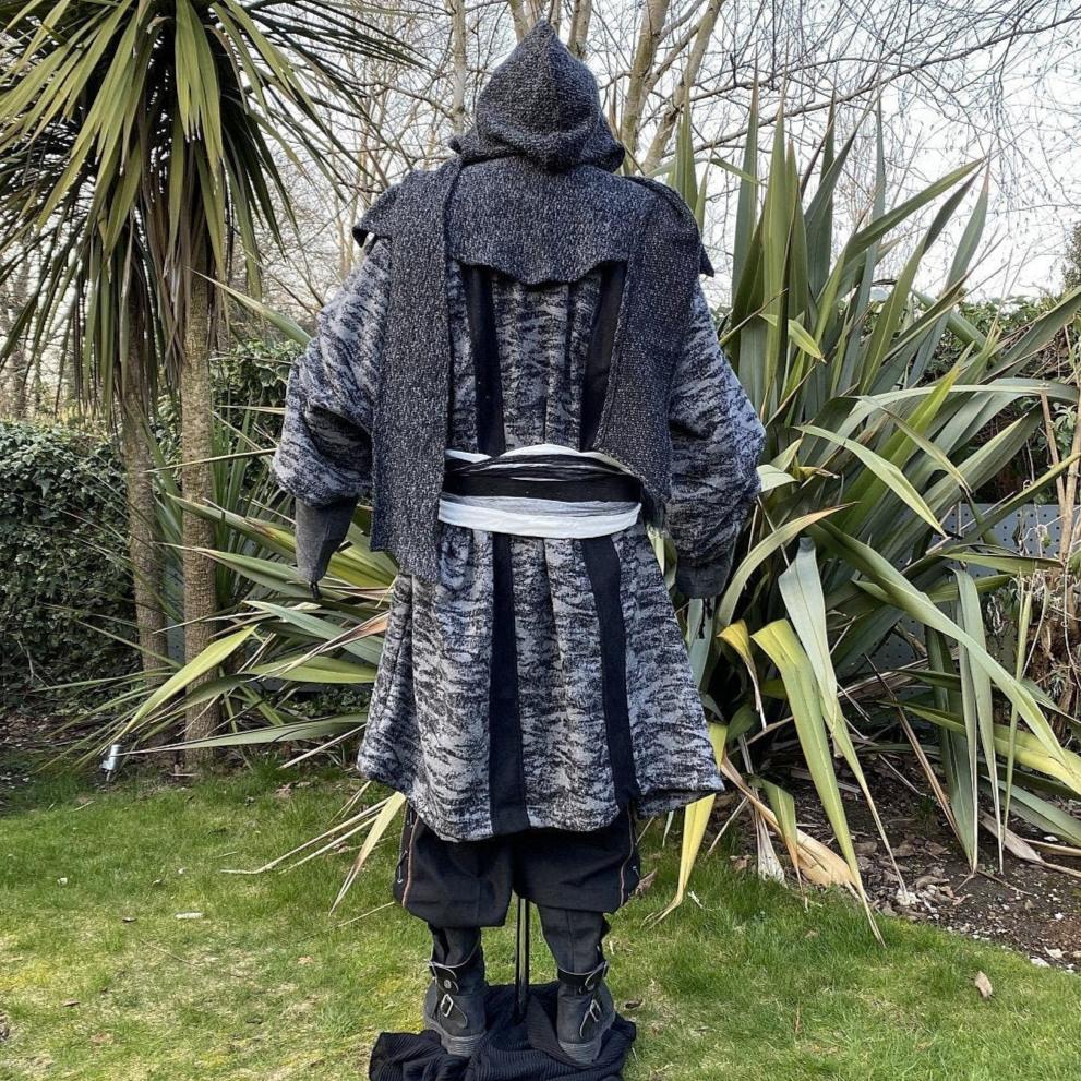 Medieval LARP costume back view, featuring grey and black hooded robe, wool hood, shirt and.