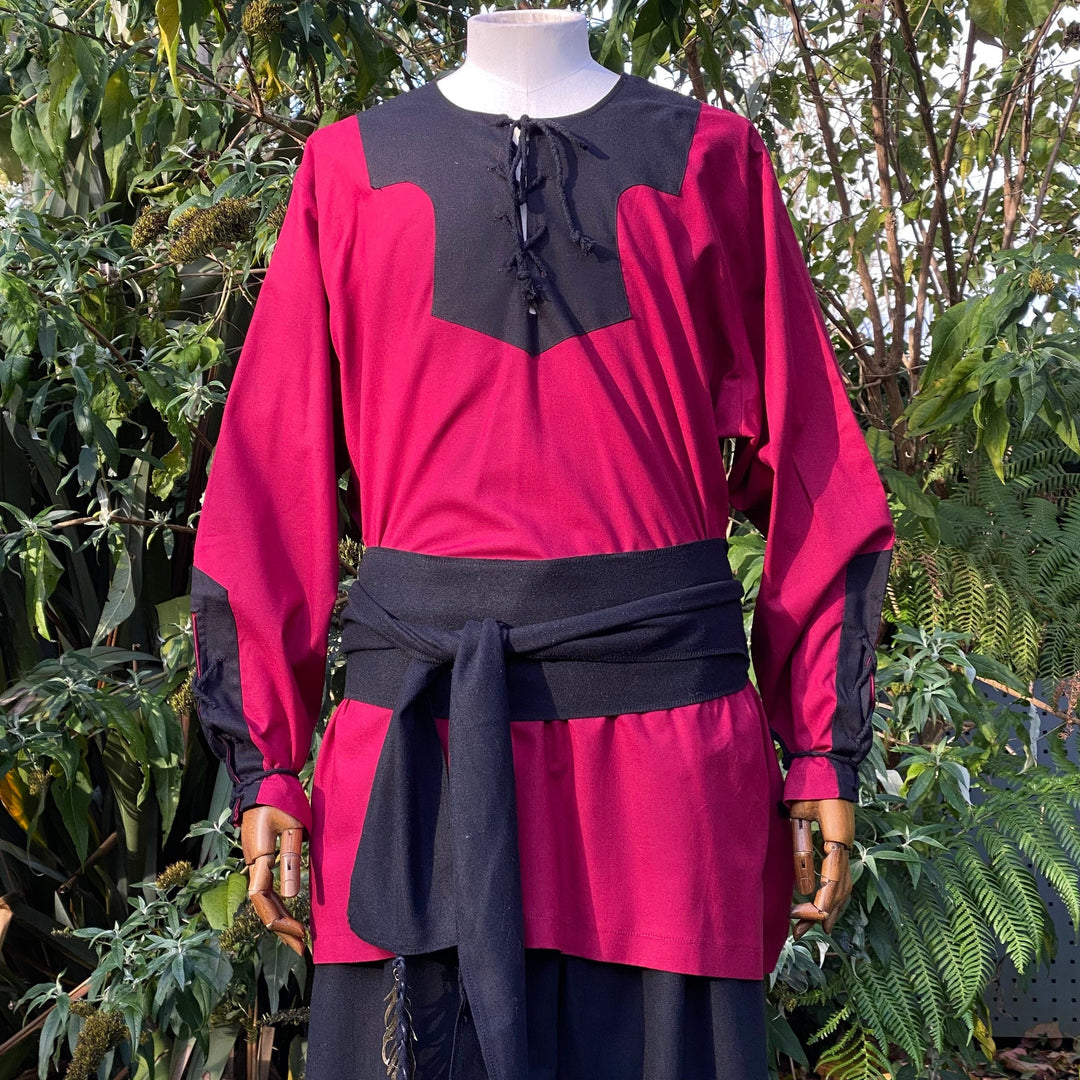 Medieval LARP attire: red-black shirt with sash detail.