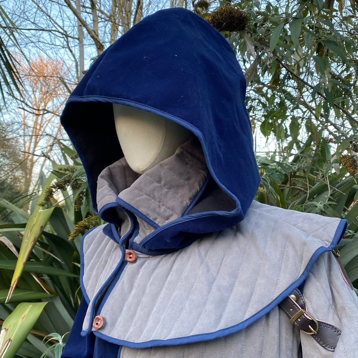 Azure LARP attire featuring grey gambeson and matching hood.
