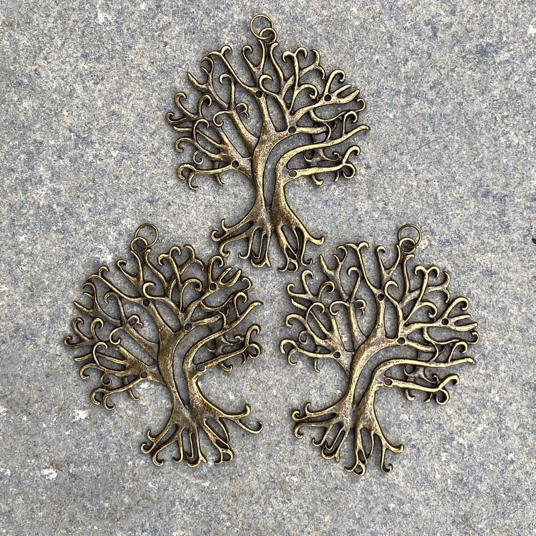 Three brass tree necklaces on stone, intricate branches, for LARP or medieval wear.