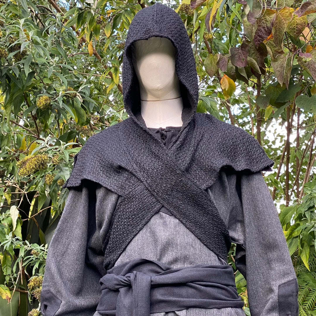 Mannequin in black medieval wrap hood with crisscross detail during LARP session.
