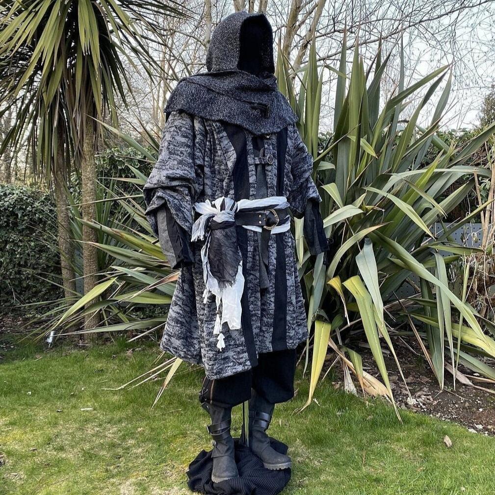 Medieval LARP costume side view, featuring grey and black hooded robe, wool hood, shirt and.