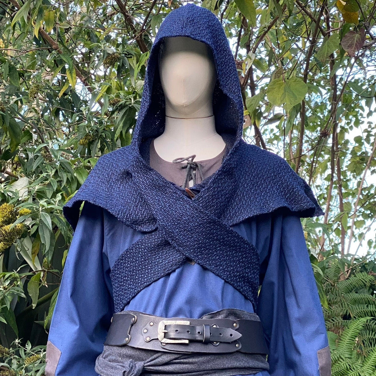 Medieval LARP outfit with blue hood and sash.
