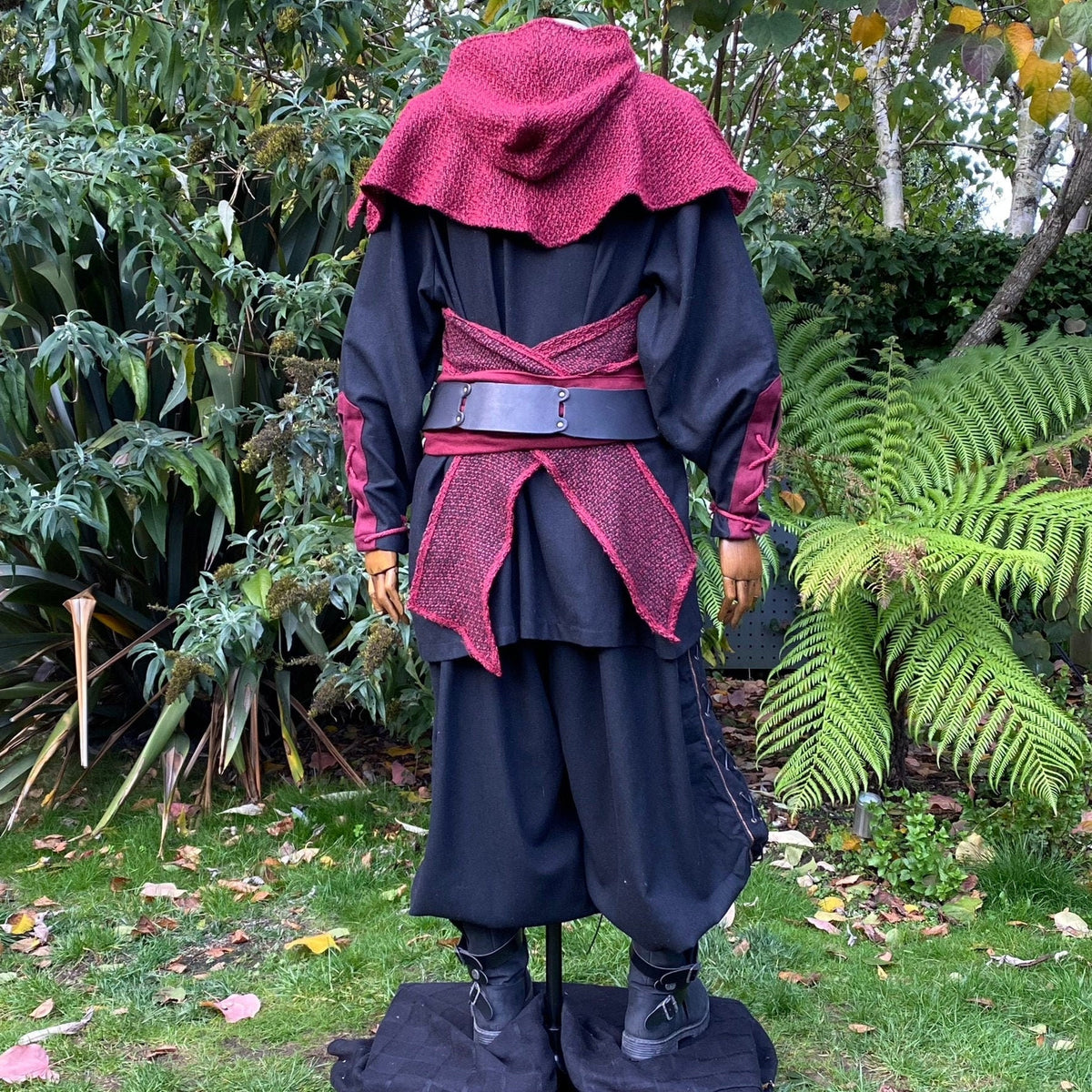 Close-up back view of red medieval LARP hood and draped sash.